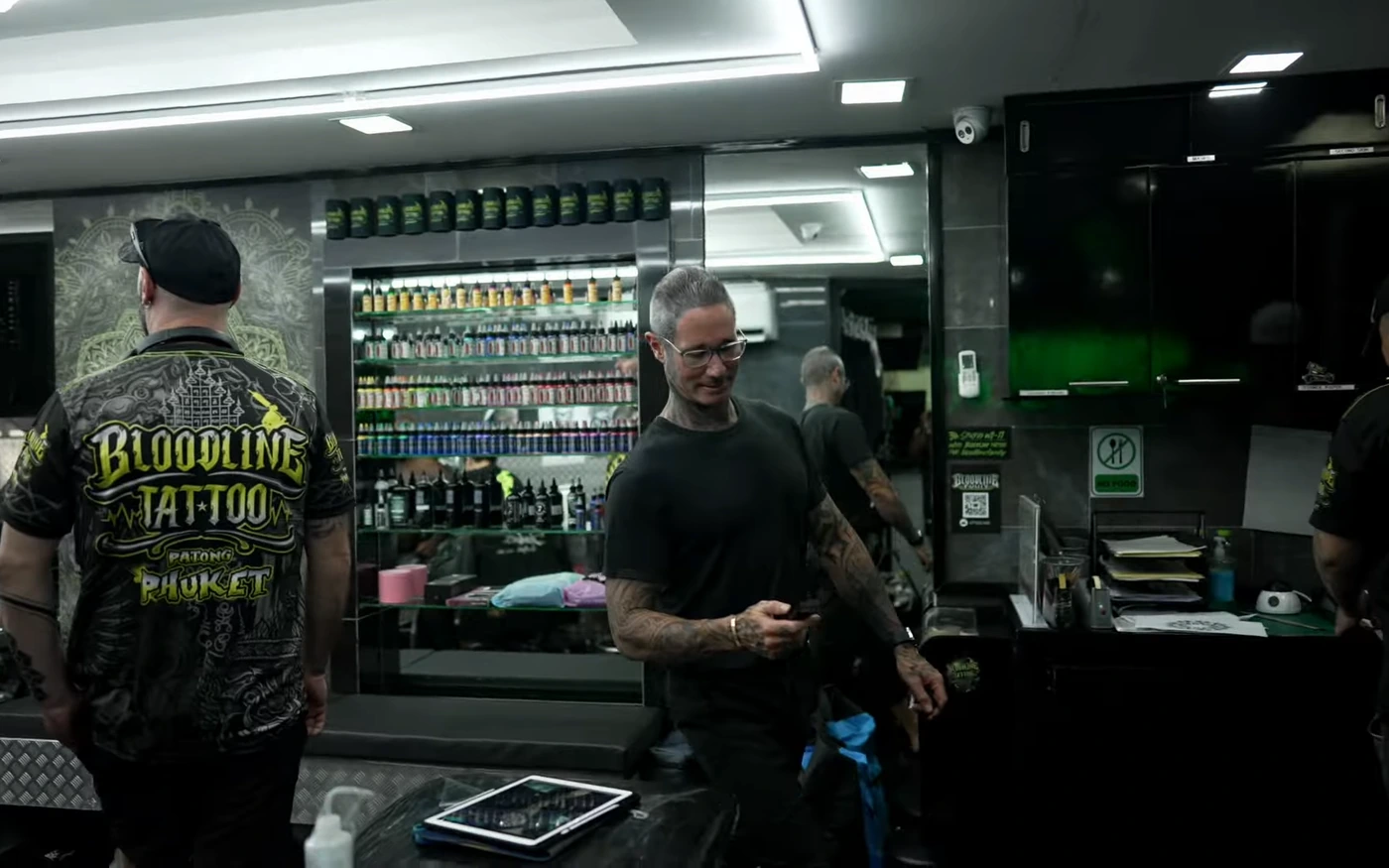 Bright professional Bloodline Tattoo Phuket studio interior with organised ink wall and staff