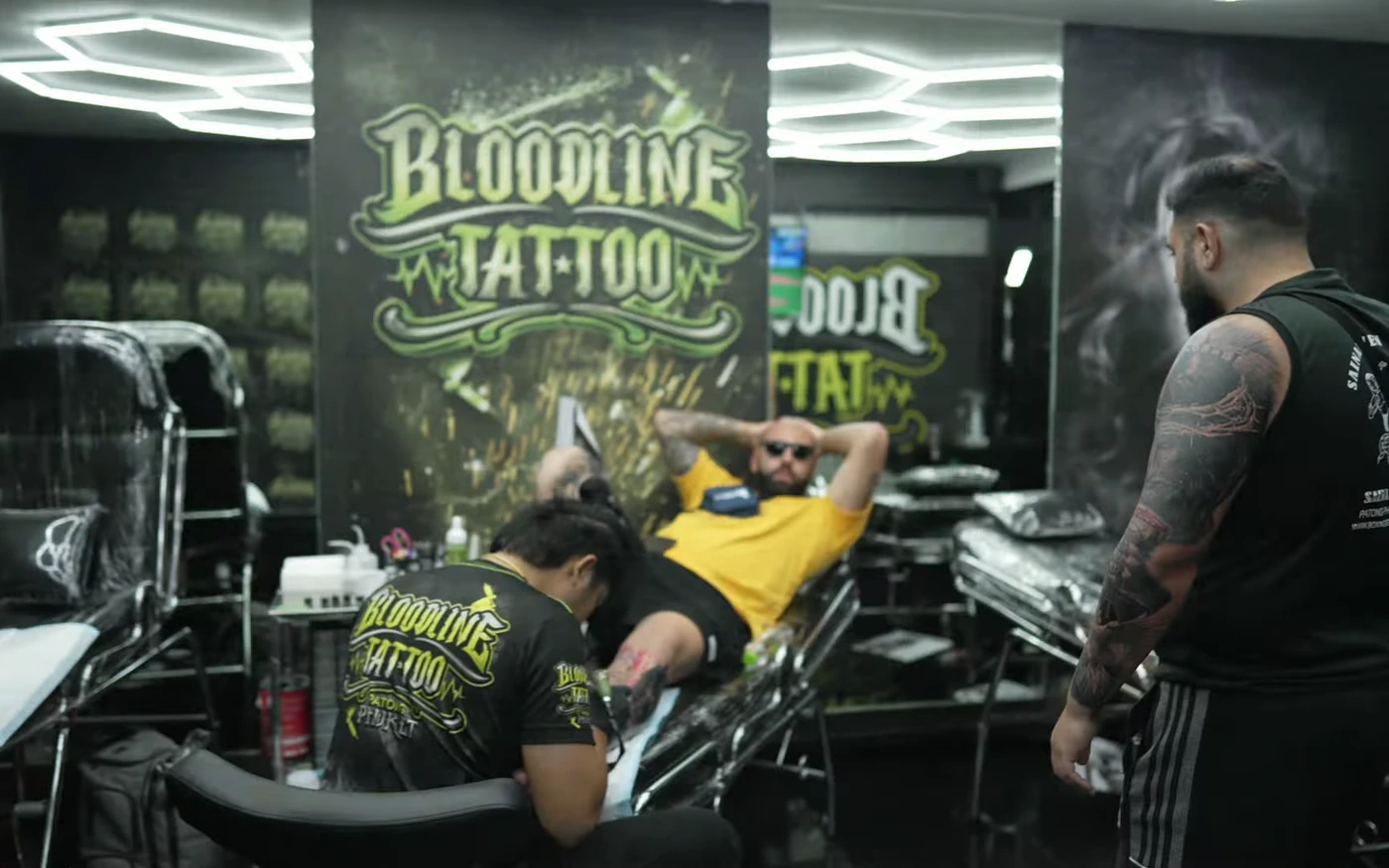 Tattoo session in progress at Bloodline Tattoo Phuket under hexagonal studio lights