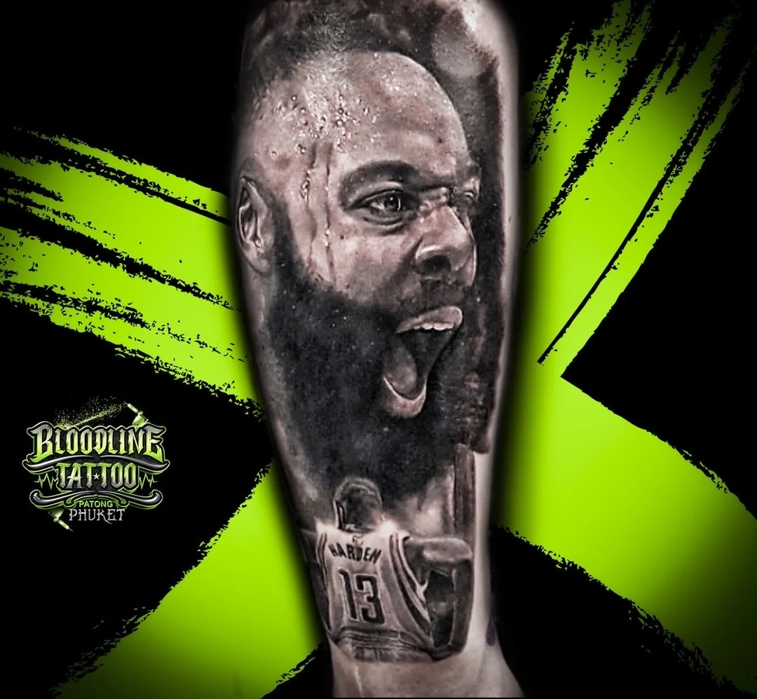 Black and grey portrait realism leg tattoo of James Harden with beard detail and HARDEN 13 jersey figure at Bloodline Tattoo Phuket.